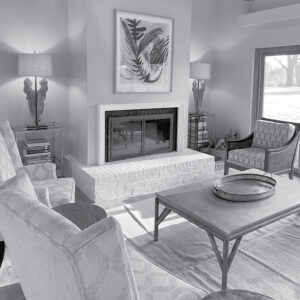 black and white photo of fireplace in living room